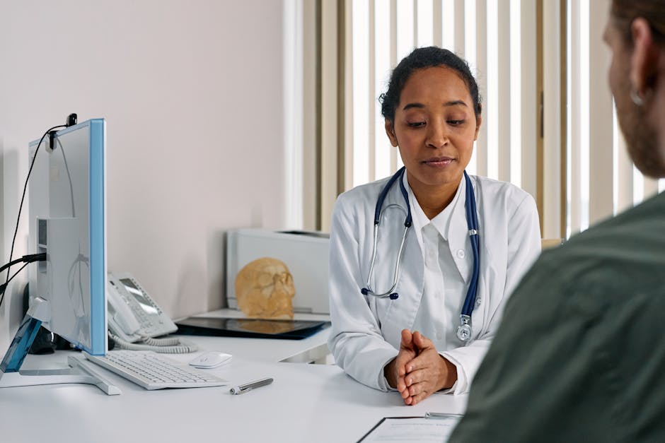 Doctor reviewing medical notes during a patient consultation