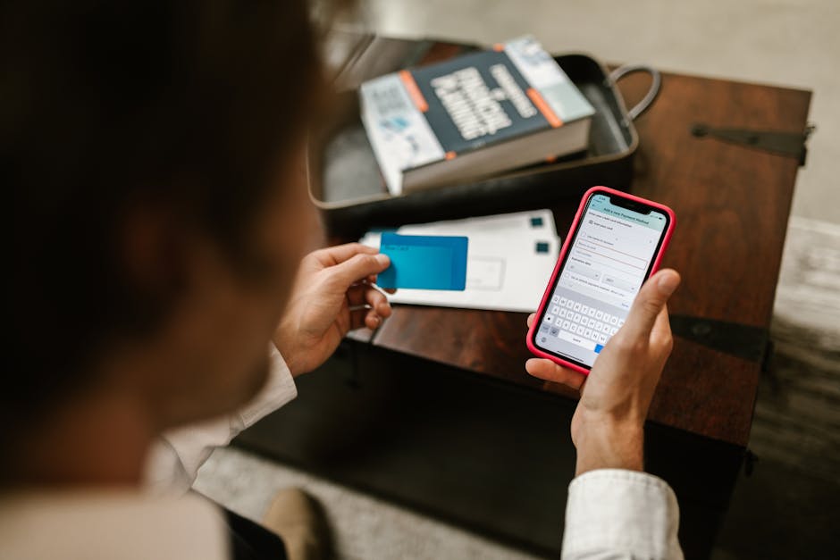 Person using a digital banking app on a smartphone showing account balance