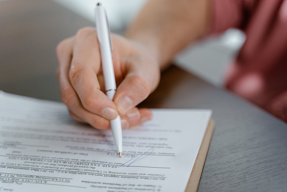 Person signing a UK will and legal estate planning documents