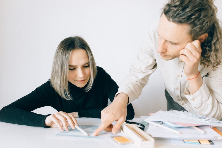 UK office workers reviewing pension paperwork — workplace pension planning