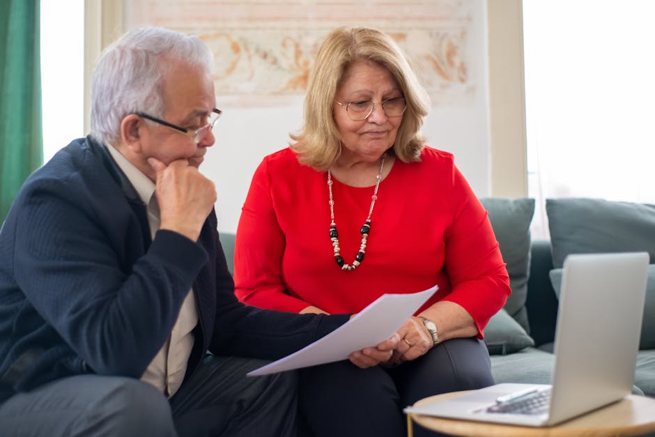 Couple in their fifties reviewing savings on a laptop
