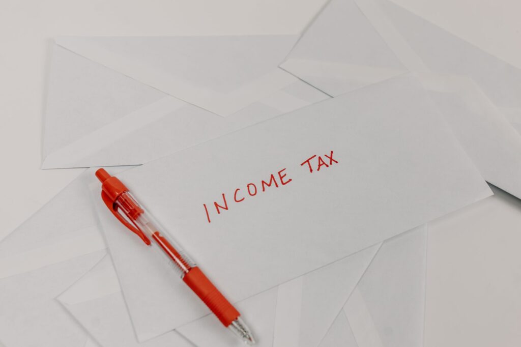 Calculator with UK tax paperwork illustrating frozen income tax thresholds and fiscal drag