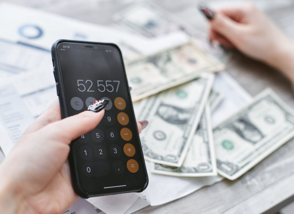 Person reviewing their mobile phone bill on a smartphone to find savings