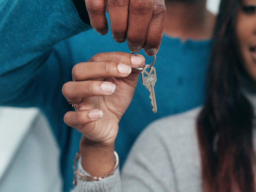 Couple holding keys to their first home