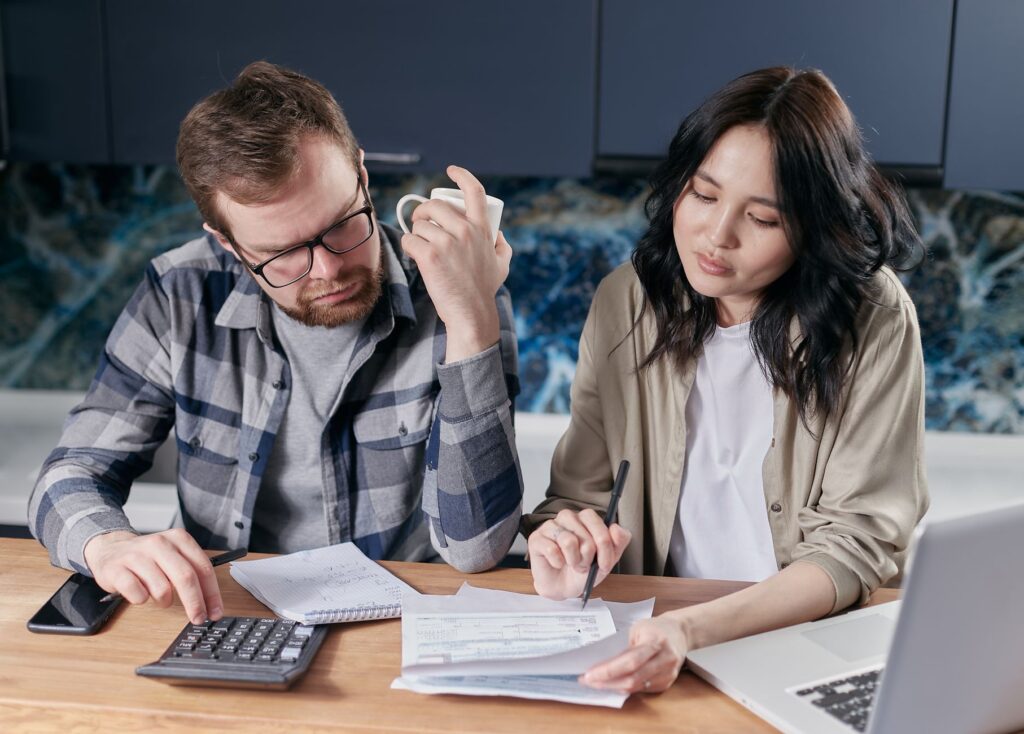 Retired UK couple checking their State Pension forecast and finances at home