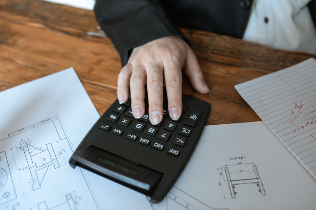 A UK payslip and P60 showing a 1257L tax code next to a calculator