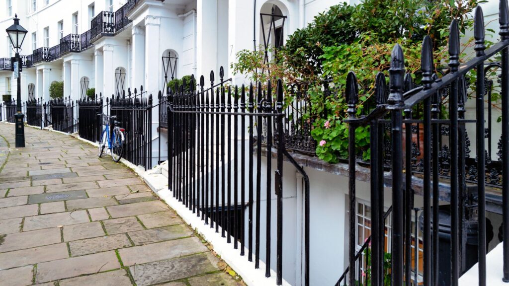 A terrace of white stucco Georgian townhouses in Kensington, London.